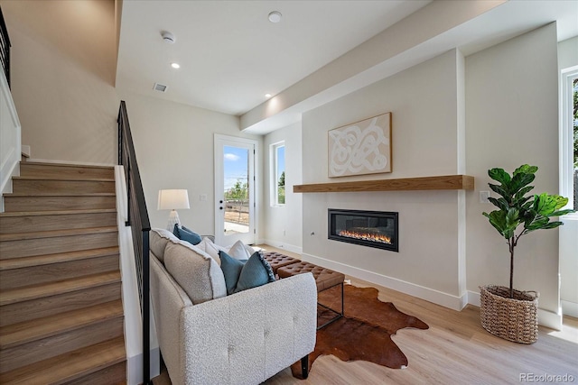 1372 Lowell Blvd Unit 1, Denver, CO 80204 - living area featuring a glass covered fireplace, stairway, healthy amount of natural light, wood finished floors, and recessed lighting