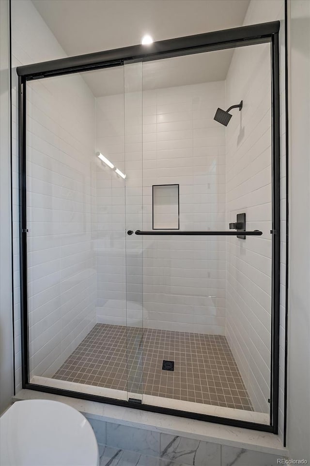 1372 Lowell Blvd Unit 1, Denver, CO 80204 - bathroom with a shower stall, toilet, marble look tiles, and recessed lighting