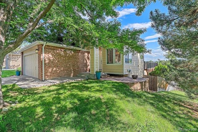 9346 W Coal Mine Ave, Littleton, CO 80123 - view of front of house featuring brick siding, an attached garage, and driveway