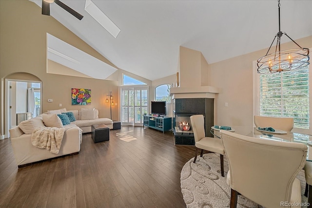 9346 W Coal Mine Ave, Littleton, CO 80123 - living area with high vaulted ceiling, a ceiling fan, a multi sided fireplace, dark wood-style floors, and a chandelier