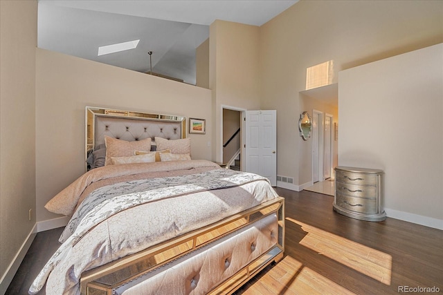 9346 W Coal Mine Ave, Littleton, CO 80123 - bedroom featuring wood finished floors, high vaulted ceiling, and a skylight