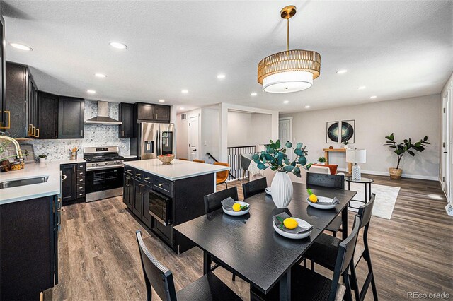6032 Estes St, Arvada, CO 80004 - dining room with recessed lighting, dark wood-type flooring, and stairway