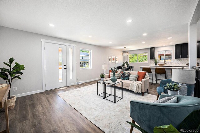 6032 Estes St, Arvada, CO 80004 - living area with dark wood-style floors, recessed lighting, and a textured ceiling
