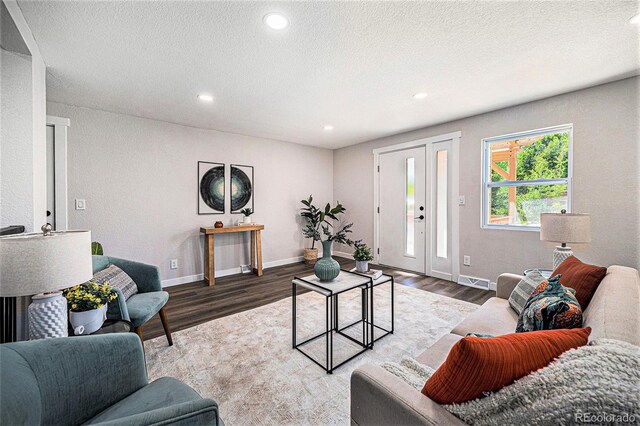 6032 Estes St, Arvada, CO 80004 - living room featuring wood finished floors, recessed lighting, and a textured ceiling