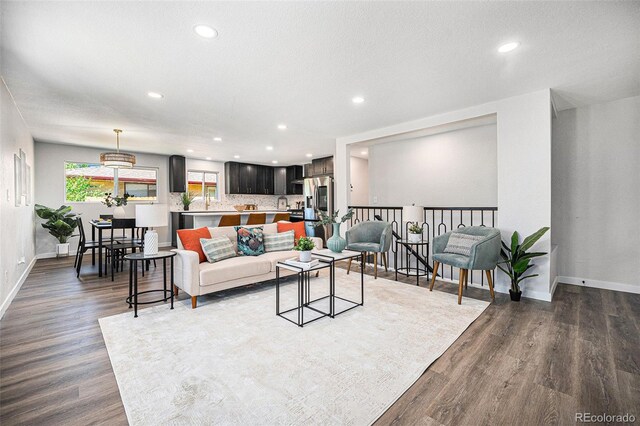 6032 Estes St, Arvada, CO 80004 - living room with recessed lighting and dark wood-type flooring
