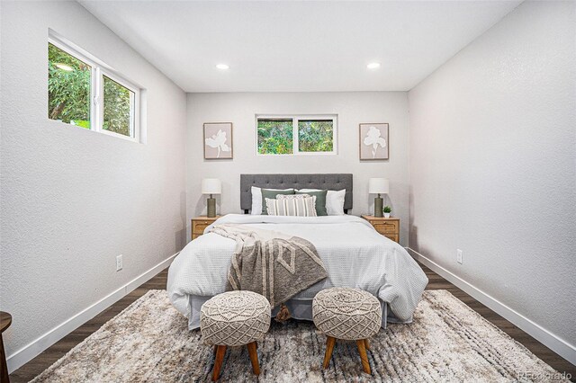 6032 Estes St, Arvada, CO 80004 - bedroom with multiple windows, dark wood-type flooring, recessed lighting, and a textured wall