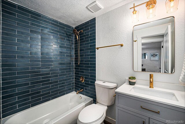 6032 Estes St, Arvada, CO 80004 - bathroom featuring a textured ceiling, vanity, tub / shower combination, and a textured wall