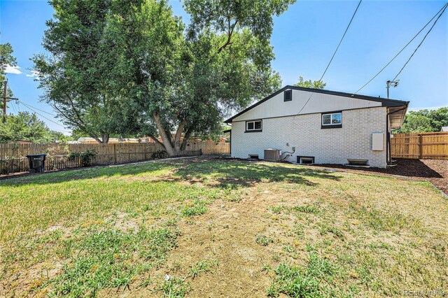 6032 Estes St, Arvada, CO 80004 - rear view of house with a fenced backyard and brick siding