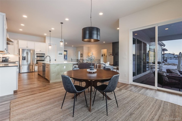 dining area featuring light hardwood / wood-style flooring and sink