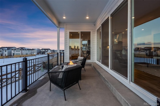 balcony at dusk with an outdoor fire pit