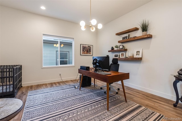 office with hardwood / wood-style flooring and a notable chandelier