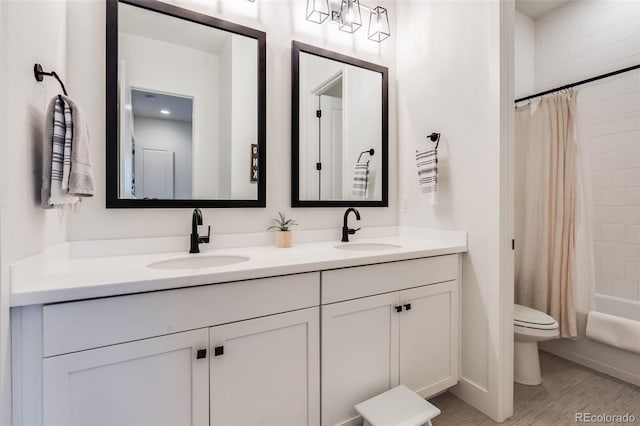 full bathroom featuring shower / tub combo, vanity, and toilet