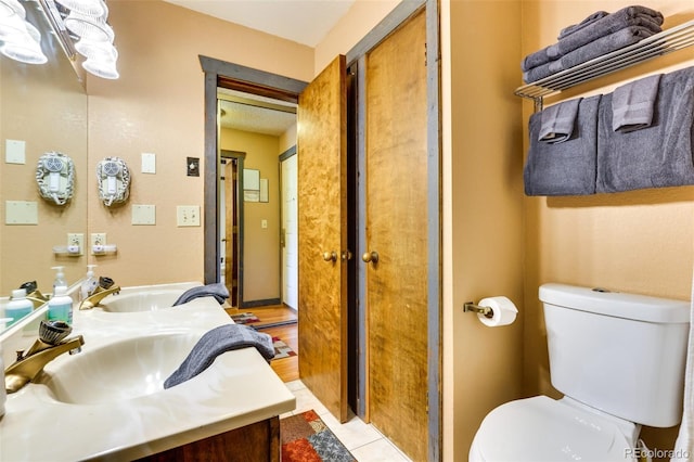 bathroom with hardwood / wood-style floors, toilet, and vanity