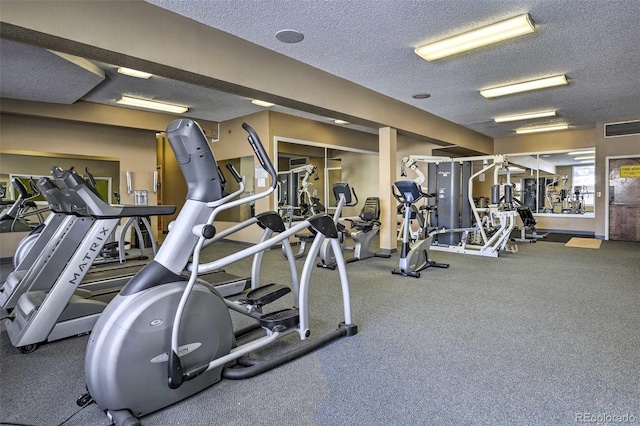 gym featuring a textured ceiling