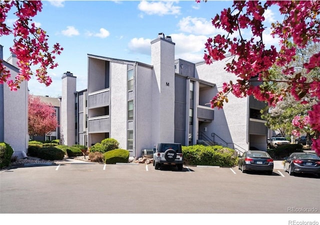 6480 S Dayton St Unit M04, Englewood, CO 80111 - view of building exterior featuring uncovered parking