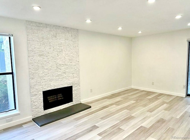 6480 S Dayton St Unit M04, Englewood, CO 80111 - unfurnished living room with a fireplace, light wood-style flooring, and recessed lighting
