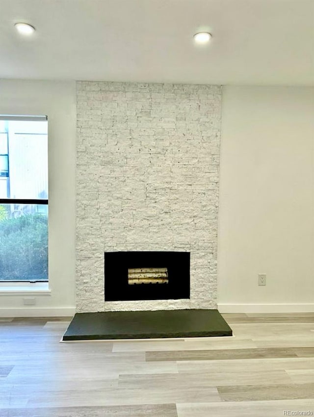 6480 S Dayton St Unit M04, Englewood, CO 80111 - detailed view of a stone fireplace, wood finished floors, and recessed lighting
