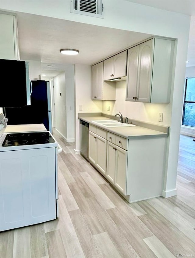 6480 S Dayton St Unit M04, Englewood, CO 80111 - kitchen with white electric stove, stainless steel dishwasher, light wood finished floors, and light countertops