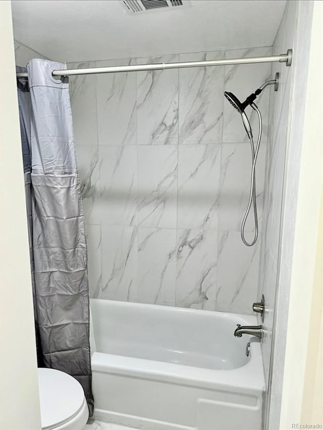 6480 S Dayton St Unit M04, Englewood, CO 80111 - bathroom featuring shower / tub combo with curtain and marble finish floors