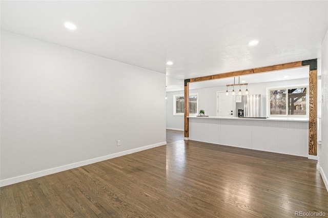 unfurnished living room featuring dark hardwood / wood-style flooring