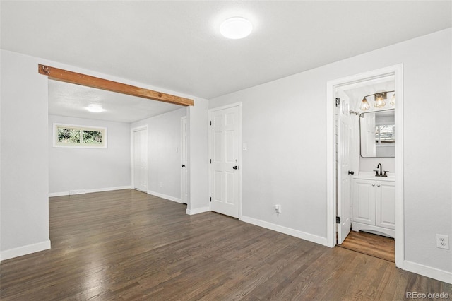 empty room with dark hardwood / wood-style flooring