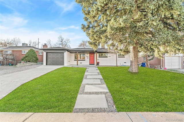 view of front of property with a garage and a front lawn