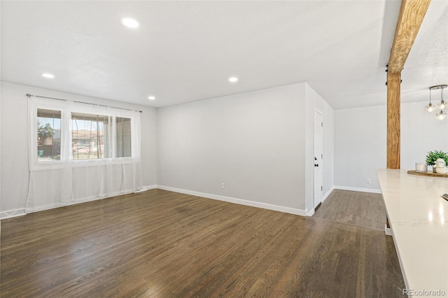 spare room with dark wood-type flooring