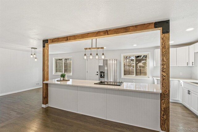 kitchen featuring white cabinets, black electric cooktop, decorative light fixtures, dark hardwood / wood-style flooring, and stainless steel fridge with ice dispenser