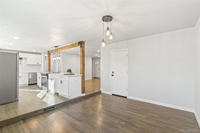 kitchen featuring white cabinets, pendant lighting, dark hardwood / wood-style flooring, and stainless steel appliances