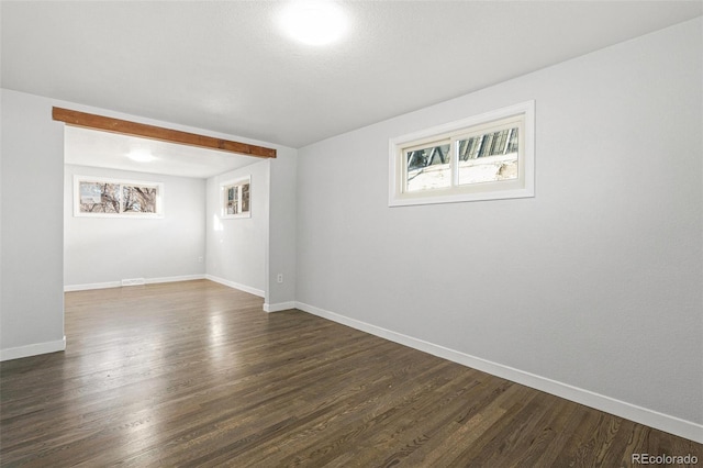 spare room with dark hardwood / wood-style floors