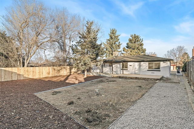 rear view of property featuring a patio area