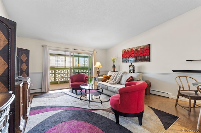 living room with light wood-type flooring, vaulted ceiling, and baseboard heating