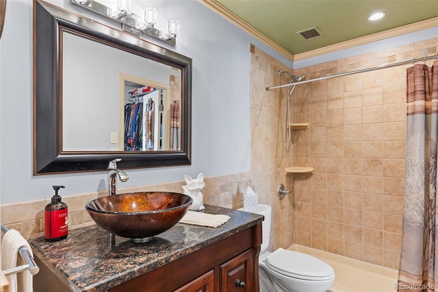 9320 E Center Ave Unit 4B, Denver, CO 80247 - bathroom with vanity, toilet, tiled shower, and crown molding