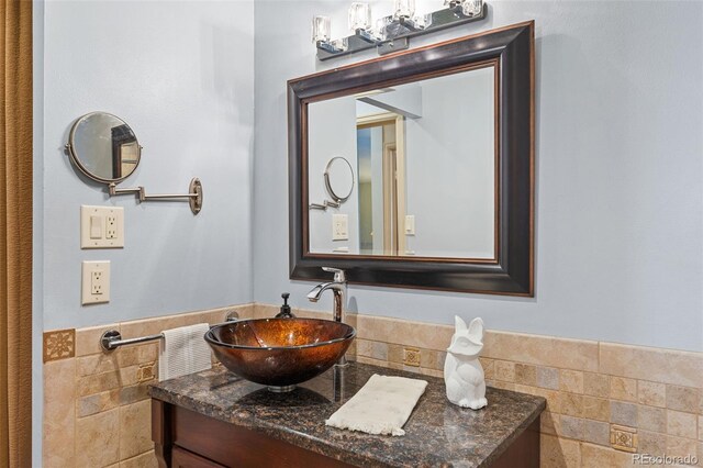 9320 E Center Ave Unit 4B, Denver, CO 80247 - bathroom featuring tile walls and vanity