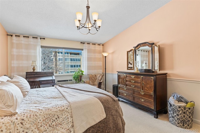 9320 E Center Ave Unit 4B, Denver, CO 80247 - bedroom featuring a chandelier, carpet floors, wainscoting, a textured ceiling, and a wall mounted AC