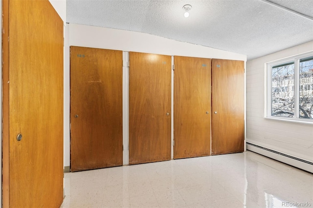 9320 E Center Ave Unit 4B, Denver, CO 80247 - unfurnished bedroom with tile patterned floors and a textured ceiling