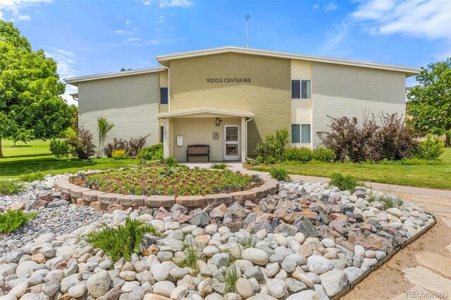 9320 E Center Ave Unit 4B, Denver, CO 80247 - view of front facade with brick siding and a front lawn