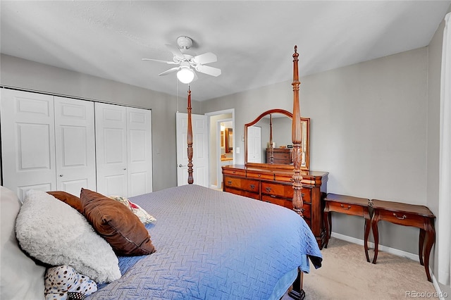 bedroom featuring ceiling fan, light colored carpet, and a closet