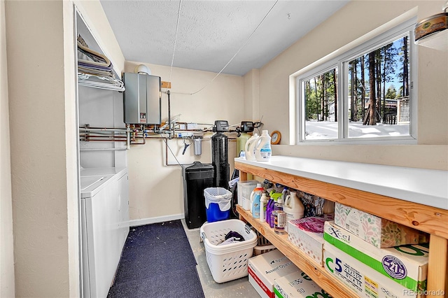 laundry room with separate washer and dryer, water heater, and a textured ceiling