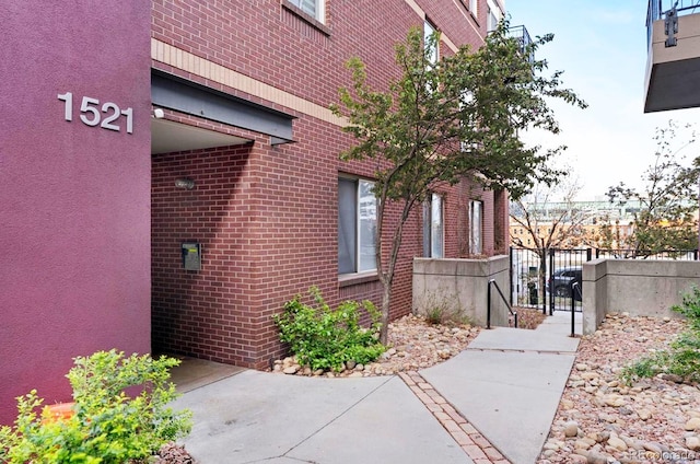 1521 Central St Unit 2D, Denver, CO 80211 - view of side of property featuring brick siding and a gate