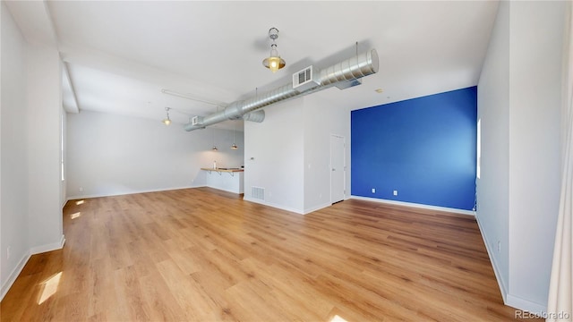 1521 Central St Unit 2D, Denver, CO 80211 - unfurnished living room with light wood-style flooring and baseboards