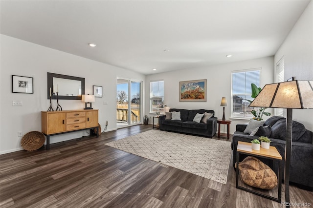 living room featuring a healthy amount of sunlight, baseboards, dark wood finished floors, and recessed lighting