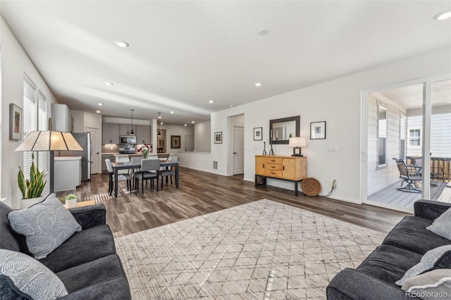 living room featuring dark wood finished floors and recessed lighting