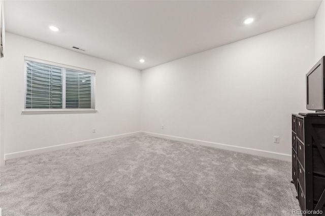 carpeted empty room with recessed lighting, visible vents, and baseboards