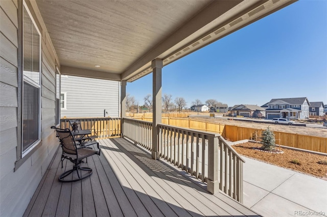 wooden deck featuring a residential view and fence