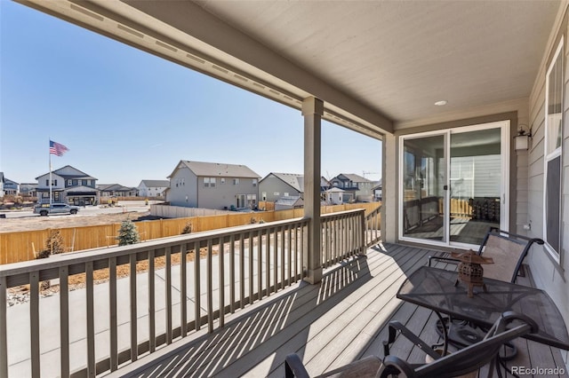 wooden deck with a residential view and fence