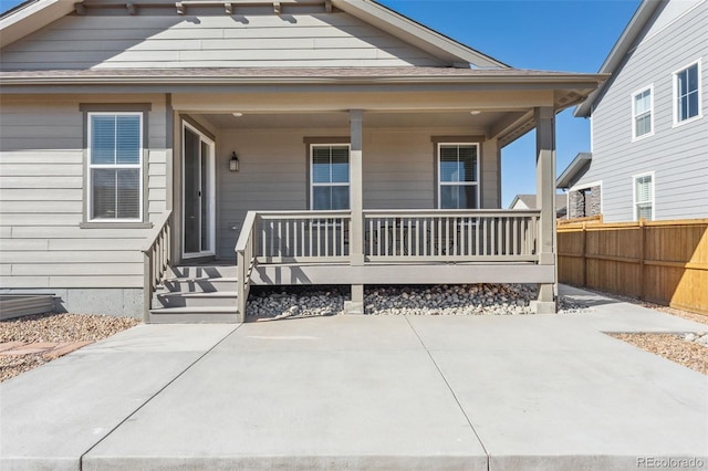 view of front of house with a porch and fence