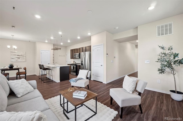 4644 High Springs Ct, Colorado Springs, CO 80917 - living area with dark wood-style floors, recessed lighting, and a chandelier