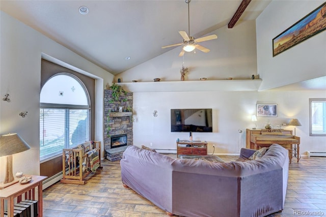 living room featuring light hardwood / wood-style floors, plenty of natural light, a fireplace, and ceiling fan