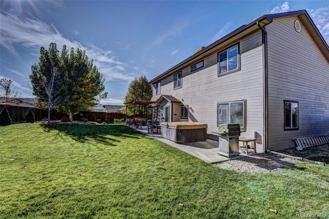 rear view of house with a patio, area for grilling, and a lawn